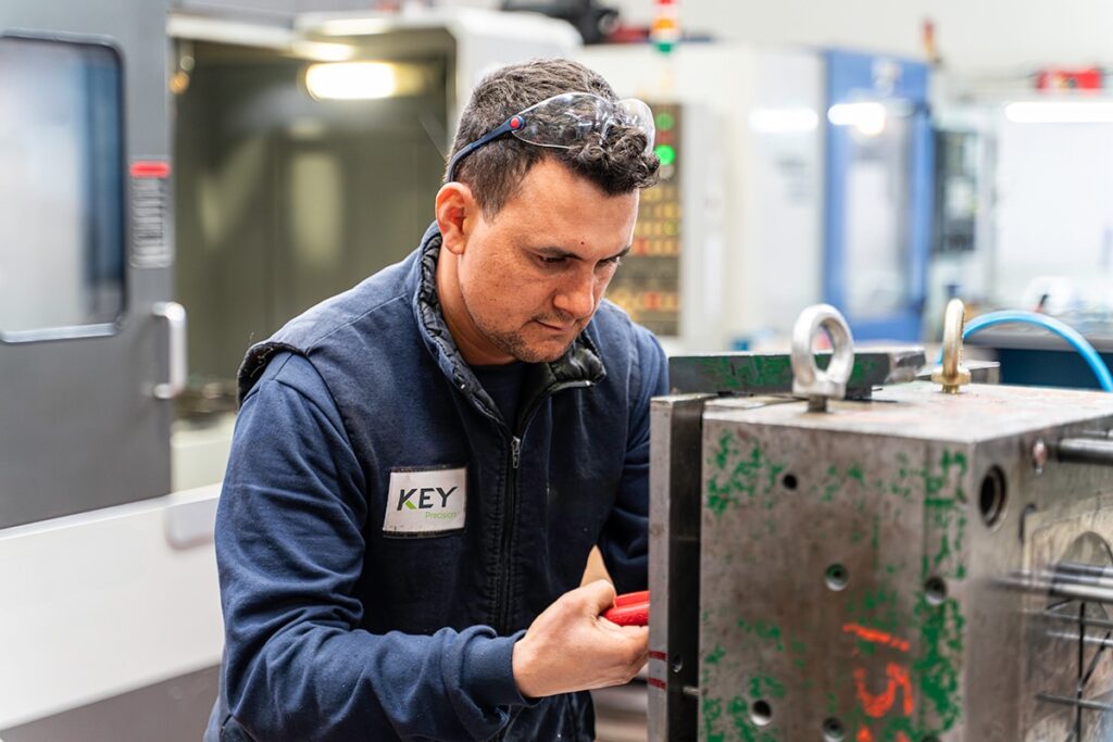 Key Precision lathe worker measuring metal mould